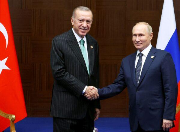 Russia's President Vladimir Putin (R) and Turkey's President Recep Tayyip Erdogan shake hands during their meeting on the sidelines of the Conference on Interaction and Confidence Building Measures in Asia (CICA) summit, in Astana, Kazakhstan, on Oct. 13, 2022. (Vyacheslav Prokofyev/Sputnik, Kremlin Pool Photo via AP)