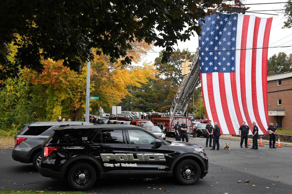 Police officers from Bristol gather with other towns at the scene where two police officers killed, in Bristol, Conn., on Oct. 13, 2022. (Jessica Hill/AP Photo)
