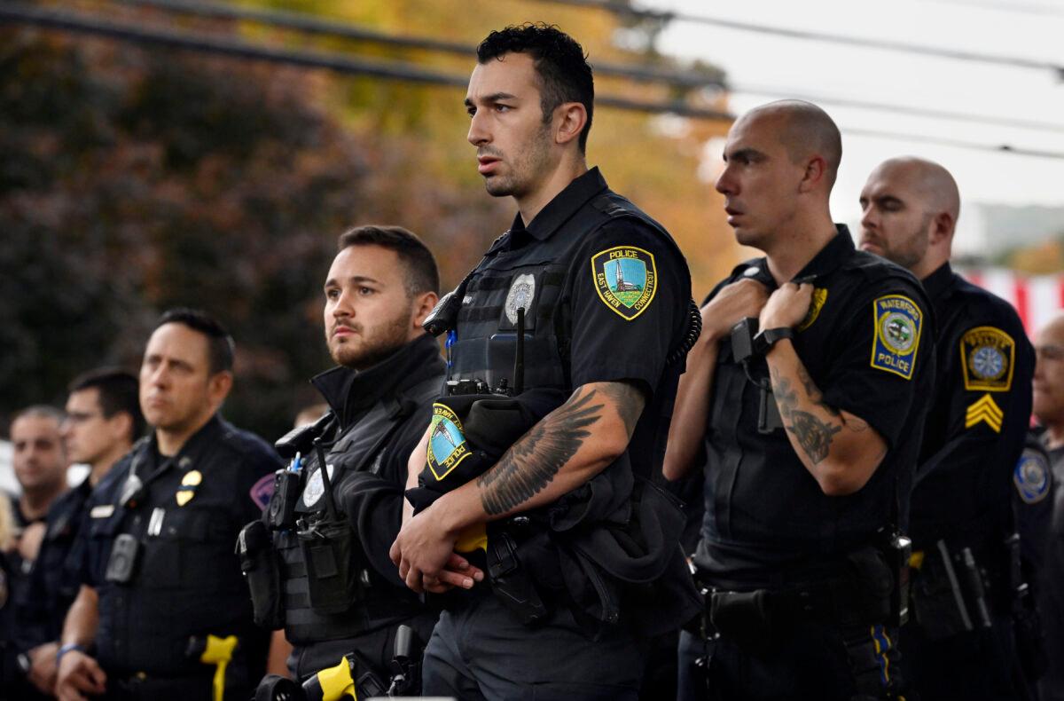 Police officers from towns across Connecticut stand at the scene where two police officers were killed, in Bristol, Conn., on Oct. 13, 2022. (Jessica Hill/AP Photo)
