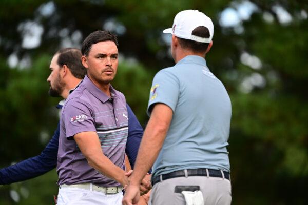 Rickie Fowler (L) and Chez Reavie (R) of the United States shake hands after holing out on the 9th green during the second round of the ZOZO Championship at Accordia Golf Narashino Country Club in Inzai, Chiba, Japan, on Oct. 14, 2022. (Atsushi Tomura/Getty Images)
