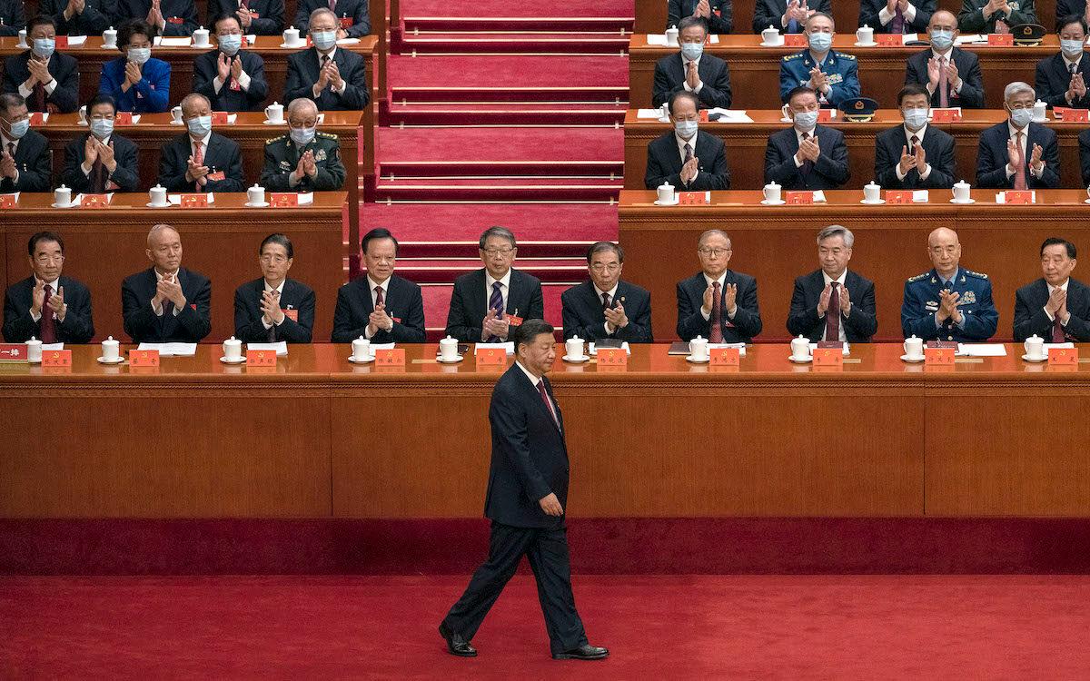Chinese leader Xi Jinping (C) is applauded by senior members of the Chinese Communist Party and delegates as he walks to the podium to make a speech during the opening ceremony of the 20th National Congress in Beijing on Oct. 16, 2022. (Kevin Frayer/Getty Images)