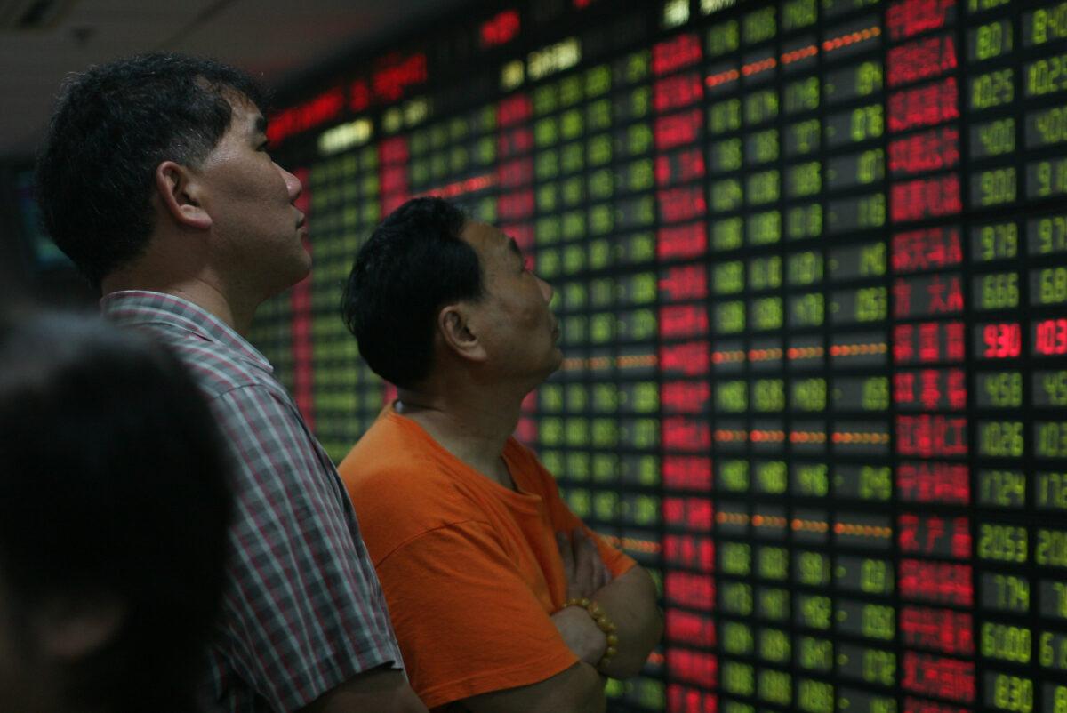 Investors view stock indexes at a securities company in Shanghai, China, on June 10, 2008. (China Photos/Getty Images)