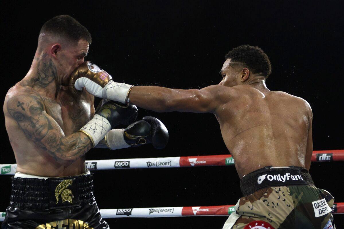 Devin Haney (R) of the United States lands a blow to the head of George Kambosos Jr. of Australia as Haney defends his undisputed lightweight boxing title in Melbourne, Australia, on Oct. 16, 2022. (Hamish Blair/AP Photo)