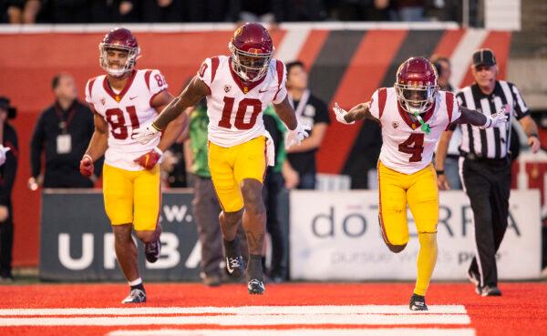 Kyron Hudson (10) of the USC Trojans celebrates scoring a touchdown with teammates Kyle Ford (81) and Mario Williams (4) during the first half of their game against the Utah Utes at Rice-Eccles Stadium in Salt Lake City, on Oct. 15, 2022. (Chris Gardner/ Getty Images)