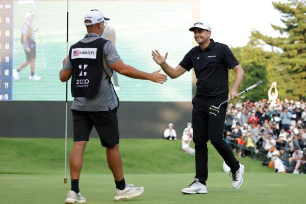 Keegan Bradley (R) of the United States celebrates winning the tournament with his caddie on the 18th green during the final round of the ZOZO Championship at Accordia Golf Narashino Country Club in Inzai, Chiba, Japan, on Oct. 16, 2022. (Chung Sung-Jun/Getty Images)