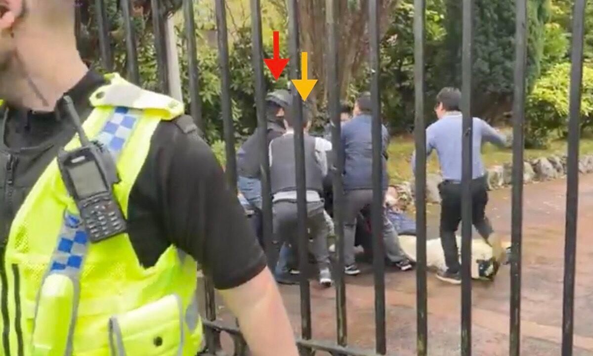 The red and yellow arrows refer to the two Chinese Consulate staff who first ran out of the Chinese Consulate gate. They later returned to the Consulate and beat a protester who was knocked to the ground. (Screenshot of video)