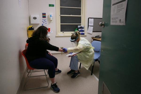 A nurse performs a consultation with a patient at a COVID-19 and flu assessment clinic in Sydney, Australia, on May 12, 2020. (Lisa Maree Williams/Getty Images)