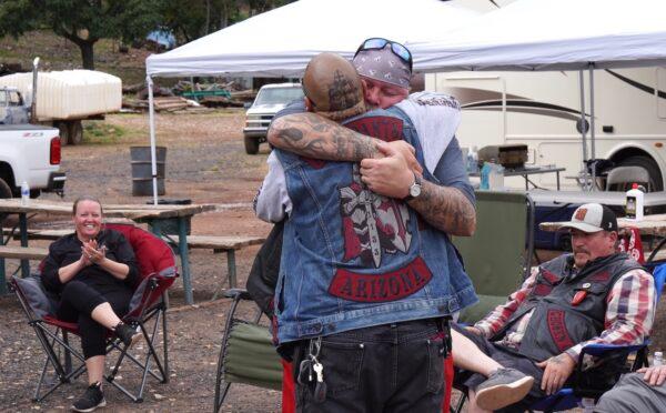 Hugging was big among the Christian bikers of the Ascendants Motorcycle Club during a family meeting in Jerome, Ariz., on Oct. 15, 2022. (Allan Stein/The Epoch Times)