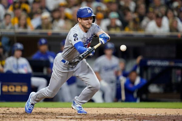 Los Angeles Dodgers' Trea Turner hits a bunt single during the seventh inning in Game 4 of a baseball NL Division Series against the San Diego Padres, in San Diego, on Oct. 15, 2022. (Ashley Landis/AP Photo)