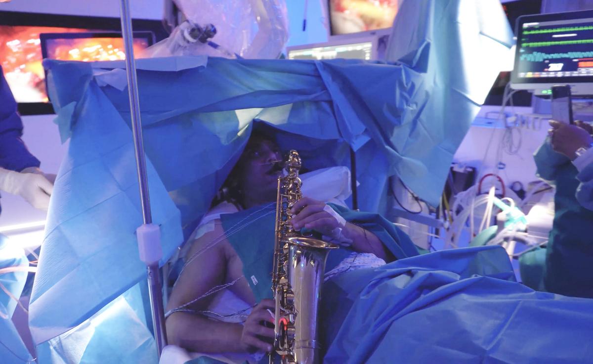 The patient, "G. Z.," plays the saxophone while undergoing brain surgery. (Courtesy of Paideia International Hospital)