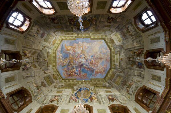 An impressive ceiling fresco by Italian fresco artist Carlo Innocenzo Carlone, in the Painted Hall in the Upper Belvedere, depicting the Triumphs of Aurora. It is typical of Rococo interiors, which often feature frescoes, as it uses a pastel palette featuring colors such as light blues, yellows, and pinks. (<a href="https://www.shutterstock.com/g/maxima">Mira Arnaudova</a><a href="https://www.shutterstock.com/image-photo/attic-belvedere-palace-vienna-21480412">/Shutterstock</a>)