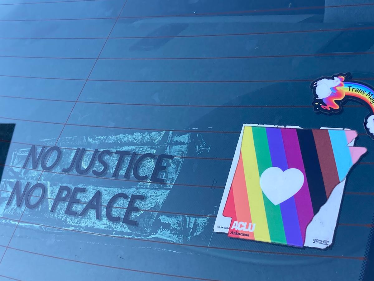 Stickers on the back of a car show support for the American Civil Liberties Union of Arkansas and for "Trans Magic," on a vehicle parked outside U.S. District Court, Little Rock, Ark, on Oct. 17, 2022. (Janice Hisle/The Epoch Times)