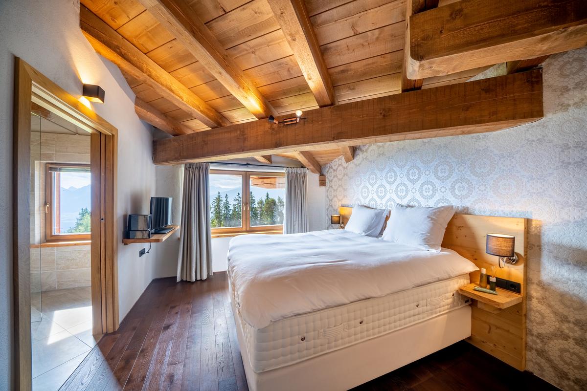One of the residence’s 13 airy bedrooms, all of which are well-it by nature and provide views of the majestic scenery. (Courtesy of the property owners, Sotheby's Concierge Auctions)