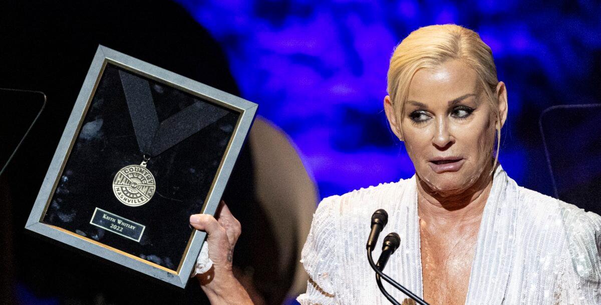 Lorrie Morgan holds a medallion accepted on behalf of her late husband and honoree Keith Whitley during the Country Music Hall of Fame Medallion Ceremony at the Country Music Hall of Fame in Nashville, Tenn., on Oct. 16, 2022. (Wade Payne/Invision/AP)