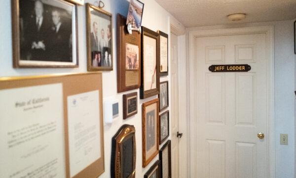 Photos and awards hang on the wall of the home of Jeff Lodder in Mission Viejo, Calif., on July 22, 2022. (John Fredricks/The Epoch Times)