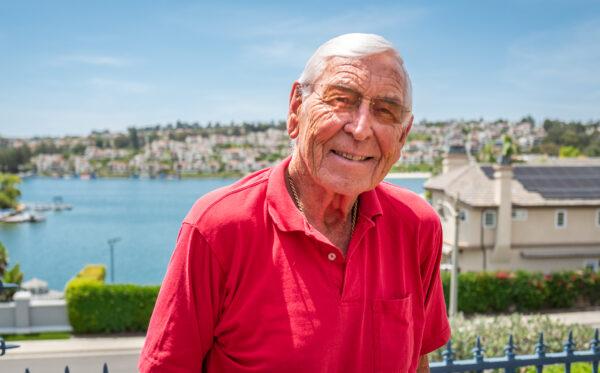 Jeff Lodder stand in his backyard overlooking Lake Mission Viejo in Mission Viejo, Calif., on July 22, 2022. (John Fredricks/The Epoch Times)