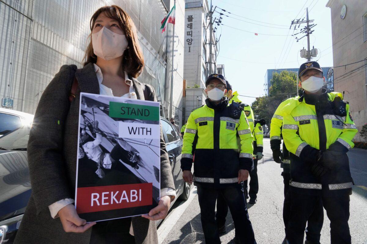 A protester attends a rally to support Iranian competitive climber Elnaz Rekabi, outside the Iranian Embassy in Seoul, South Korea, on Oct. 19, 2022. (Ahn Young-joon/AP Photo)