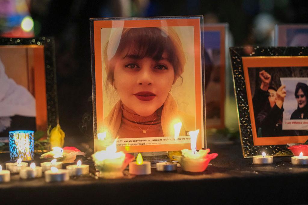 Candles and pictures of Mahsa Amini are placed at a memorial during a candlelight vigil for Mahsa Amini who died in custody of Iran's morality police, in Los Angeles Sept. 29, 2022. (Ringo Chiu/AFP via Getty Images)