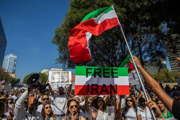 Demonstrators hold Iran's flag during a protest for Mahsa Amini, who died in the custody of Iran's morality police, in Los Angeles on Oct. 1, 2022. (Apu Gomes/AFP via Getty Images)