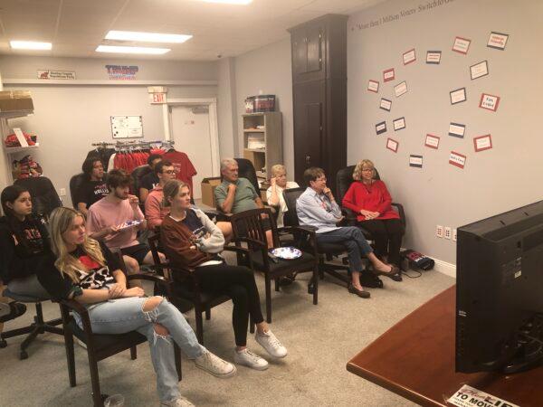 Members of the Alachua County Republican Executive Committee and University of Florida students, who work on the Rubio campaign, gather at GOP headquarters in Gainesville, Fla. to share pizza and watch the debate together. (The Epoch Times/Nanette Holt)