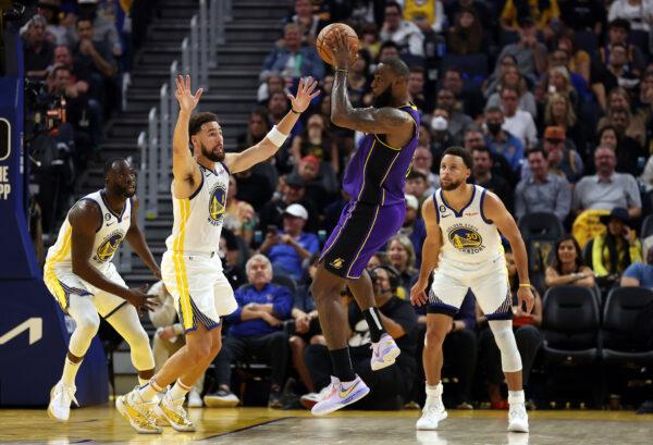 LeBron James (6) of the Los Angeles Lakers looks to pass as Klay Thompson (11), Stephen Curry (30), and Draymond Green (23) of the Golden State Warriors defend during the 1st half of the game at Chase Center in San Francisco, on October 18, 2022. (Ezra Shaw/Getty Images)