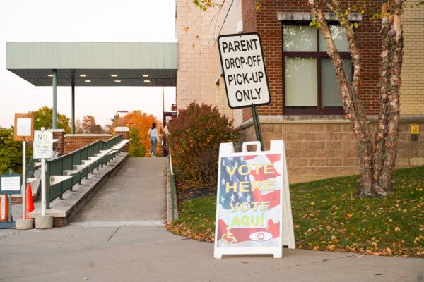Residents enter the Otisville Elementary School building to vote on the Minisink Valley District public library referendum, in Otisville, N.Y., on Oct. 18, 2022. (Cara Ding/The Epoch Times)