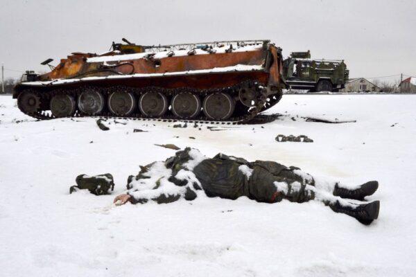 The body of a Russian serviceman lies near destroyed Russian military vehicles on the roadside on the outskirts of Kharkiv, Ukraine, on Feb. 26, 2022. (Sergey Bobok/AFP via Getty Images)