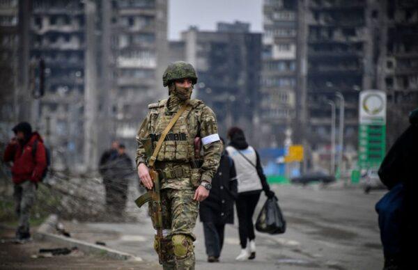 A Russian soldier patrols a street in Mariupol, Ukraine, on April 12, 2022. (Alexander Nemenov/AFP via Getty Images)