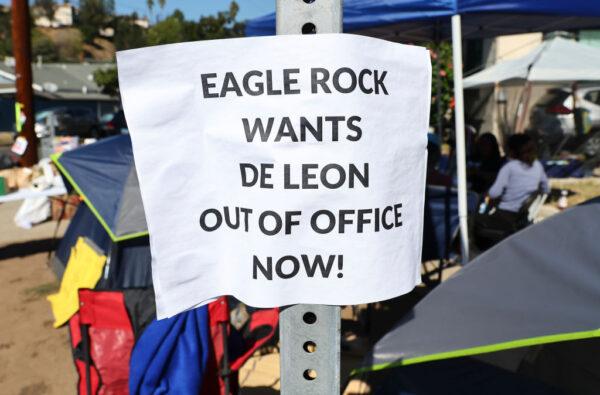 A sign calling for the resignation of L.A. City Council member Kevin de Leon is posted at a protest encampment near de Leon's home in the wake of a leaked audio recording in Los Angeles on Oct. 18, 2022. (Mario Tama/Getty Images)
