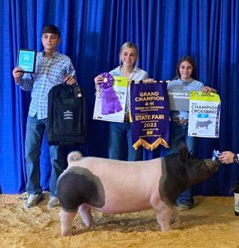 Tinsman's children receive an award for their hog winning grand champion at the Indiana State Fair in August 2022. (Courtesy of Joe Tinsman)