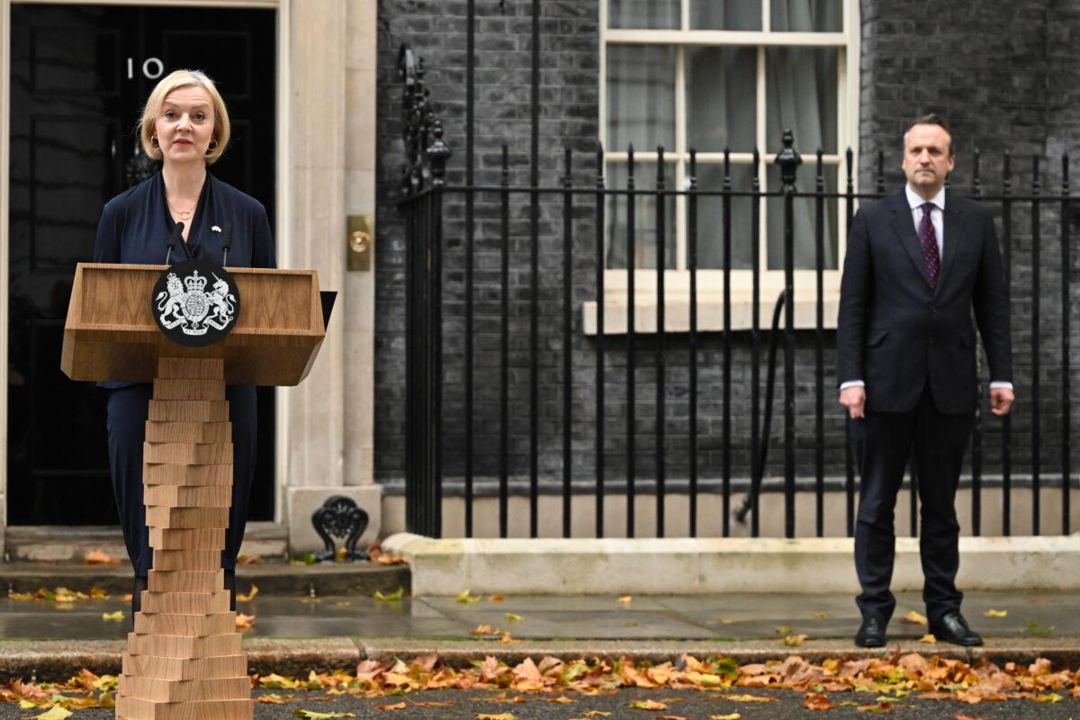 Prime Minister Liz Truss, watched by her husband, Hugh O'Leary, announces her resignation at 10 Downing Street, London, on Oct. 20, 2022. (Leon Neal/Getty Images)