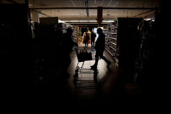 People shop in a supermarket as Kharkiv suffers an electricity outage, in Kharkiv, Ukraine, on Oct. 17, 2022. (Clodagh Kilcoyne/Reuters)