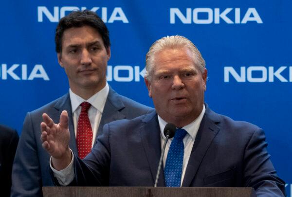 Prime Minister Justin Trudeau looks on as Ontario Premier Doug Ford responds to a question following an announcement in Ottawa on Oct. 17, 2022. (Adrian Wyld/The Canadian Press)