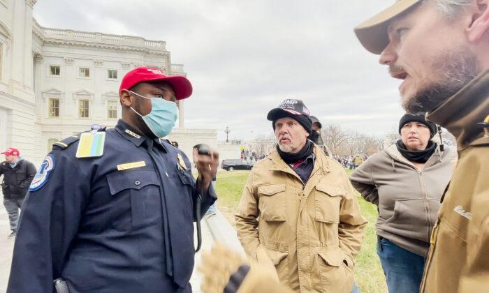 U.S. Capitol Police Lt. Tarik Khalid Johnson asks Oath Keepers Steve Nichols (C) and Michael Nichols for help rescuing police officers trapped inside the Capitol on Jan. 6, 2021. (Rico La Starza/Special to The Epoch Times)
