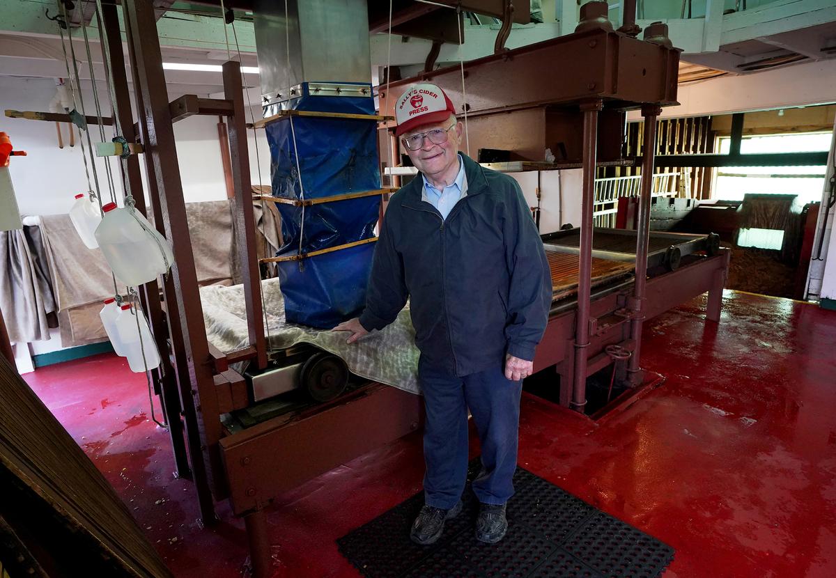 Tom Davis, 83, poses in front of his antique press at Sally's Cider Press in Harmony, Pa., on Oct. 6, 2022. (Courtesy of Pittsburgh Post-Gazette/TNS)