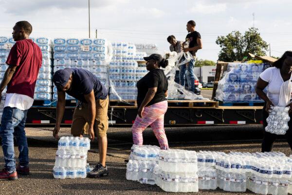 Cases of bottled water are handed out at a Mississippi Rapid Response Coalition distribution site in Jackson, Miss., on Aug. 31, 2022. (Brad Vest/Getty Images)