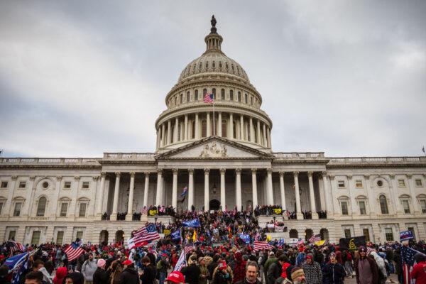 A large group of protesters stand on the East steps of the Capitol Building after breaching its grounds in Washington, D.C., on Jan. 6, 2021. (Jon Cherry/Getty Images)
