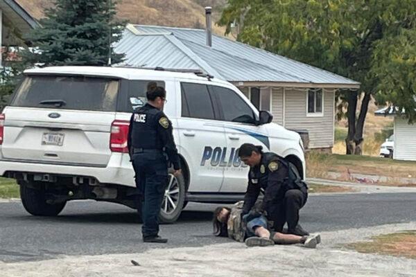 Police arrest a shooting suspect outside a resident's home in Nespelem, Wash., on Oct. 21, 2022. (Robin Redstar via AP)