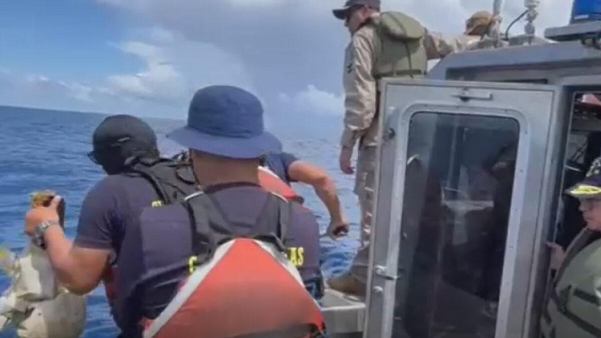 Rescue workers pull debris from the sea on Oct. 22, 2022, after a small plane crashed into the Caribbean just off the Costa Rican coast, in a still from video. (Costa Rica Public Security via AP/Screenshot via NTD)