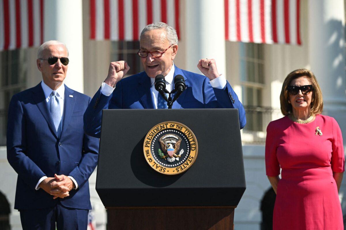 President Joe Biden (L) and House Speaker Nancy Pelosi (D-Calif.) (R) listen as Senate Majority Leader Chuck Schumer (D-N.Y.) speaks at an event at the White House in Washington on Aug. 9, 2022. (Saul Loeb/AFP/Getty Images)