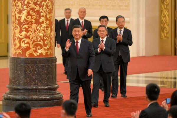 Chinese leader Xi Jinping (front) walks with members of the Chinese Communist Party's new Politburo Standing Committee, the nation's top decision-making body, as they meet the media in Beijing on Oct. 23, 2022. (Wang Zhao/AFP via Getty Images)