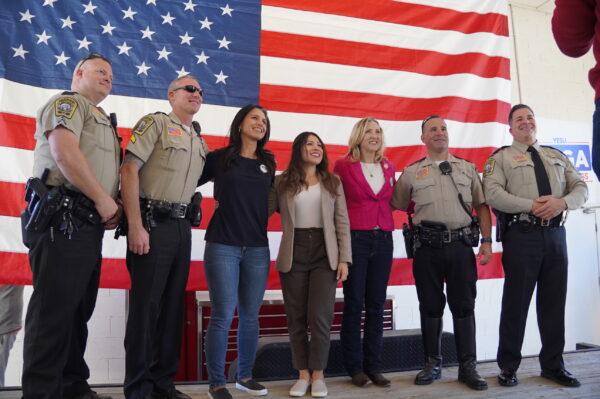 Former U.S. Congresswoman Tulsi Gabbard (3rd L), Republican congressional candidate Yesli Vega (4th L), and Virginia Delegate Tara Durant pose with deputies at the Stafford County Sheriff's Office at a campaign event for Vega in Fredericksburg, Va., on Oct. 22, 2022. (Terri Wu/The Epoch Times)