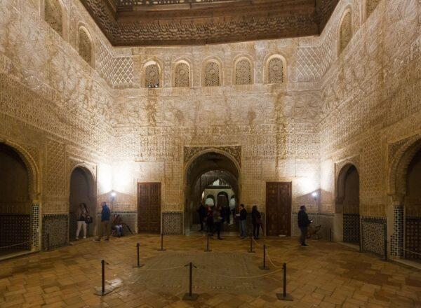 An overview of the Hall of the Ambassadors, a 37-foot square room in the Comares Tower and the largest room in the Alhambra. This throne room contains some of the most diverse architectural and decorative elements of the complex, such as the double-arched windows, the arched lattice windows on high walls, intricate geometric details on the walls, the ceramic tiles, and complex carved stucco motifs with calligraphy and patterns. (<a href="https://www.shutterstock.com/g/jackf">BearFotos</a>/<a href="https://www.shutterstock.com/image-photo/granada-spain-may-12-2016-hall-749423365">Shutterstock</a>)