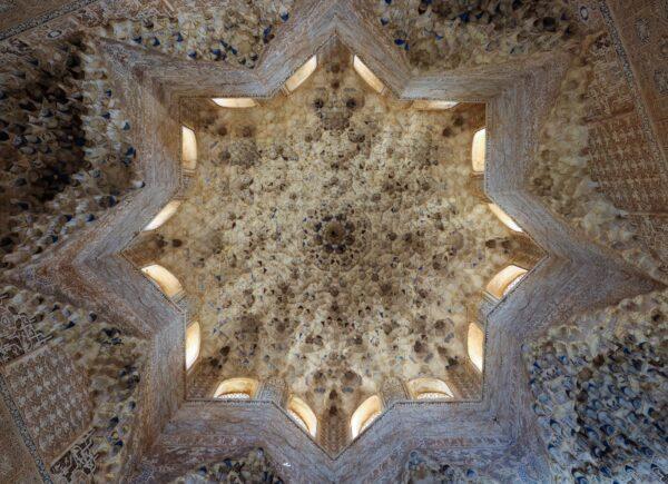 A closer look at the beautiful intricate ceiling of the Hall of the Kings shows the star motif that's common in Islamic architecture. It's decorated with carved and painted stucco. This is an example of vaulted muqarnas, a method of ornamented vaulting using three-dimensional, honeycomb-like decorative elements. (<a href="https://www.shutterstock.com/g/MrFred">MrFred</a>/<a href="https://www.shutterstock.com/image-photo/moorish-ceiling-art-hall-kings-nasrid-1701114889">Shutterstock</a>)