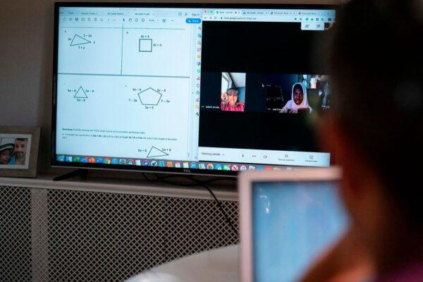 A teacher helps his sixth-grade students solve math problems during virtual office hours from his apartment in Washington on Apr. 7, 2020. (Alex Edelman/AFP via Getty Images)
