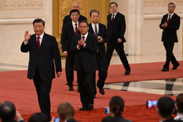 China's leader Xi Jinping (front) walks with members of the Chinese Communist Party's new Politburo Standing Committee, the nation's top decision-making body, as they meet the media in the Great Hall of the People in Beijing on Oct. 23, 2022. (Noel Celis / AFP via Getty Images)