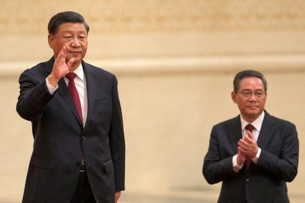 China's leader Xi Jinping (L) waves with Li Qiang (R), a member of the Chinese Communist Party's new Politburo Standing Committee, as they meet the media in the Great Hall of the People in Beijing on Oct. 23, 2022. (Wang Zhao/AFP via Getty Images)