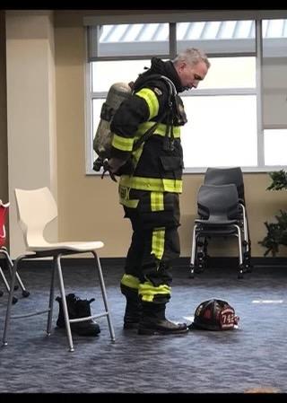 Firefighter Shawn Hayston participates in the Great American Teach-In, showing students at his son's school how he gears up to respond to calls for help. (Courtesy of Shawn Hayston)