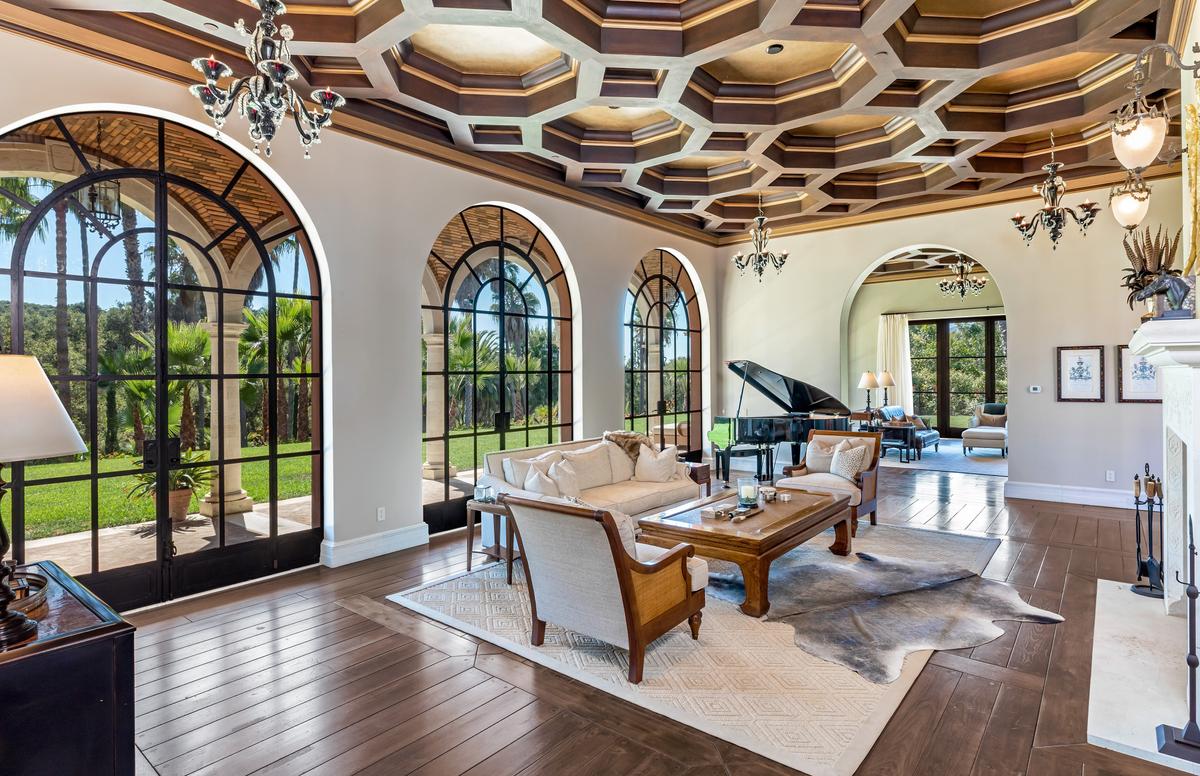 The living area features vaulted and coffered ceilings, custom steel frame windowed doors, and handcrafted stone, hardwood, and vintage tile. (Courtesy of Simon Berlyn for Sotheby’s International Realty)