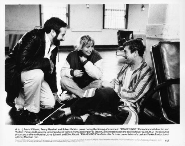 Lobby card showing (L–R) Robin Williams, director Penny Marshall, and Robert De Niro conferring on the set of "Awakenings." (MovieStillsDB)